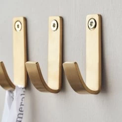 Meraki - Thapsus Haak -Meubilair Verkoopwinkel Meraki Thapsus Haken mattes Messing Finish 3er Set Reihe Wand Ambiente